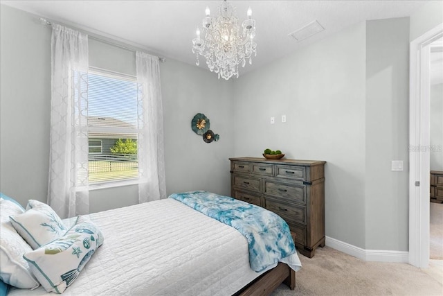 bedroom featuring baseboards, a notable chandelier, light carpet, and visible vents