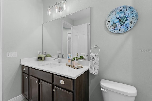 bathroom featuring toilet and vanity