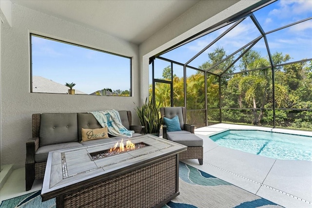 exterior space with a lanai, a patio area, and an outdoor living space with a fire pit