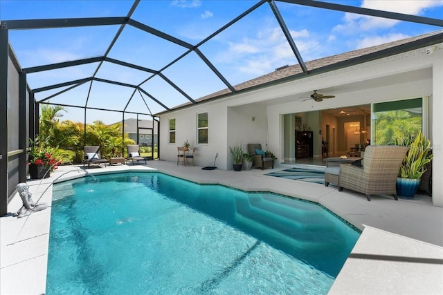 pool with a lanai, a patio, and a ceiling fan