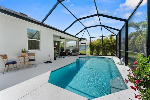 outdoor pool featuring a patio, ceiling fan, outdoor lounge area, and glass enclosure