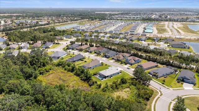 birds eye view of property with a water view and a residential view