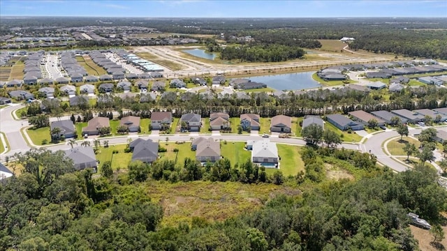 drone / aerial view featuring a water view and a residential view