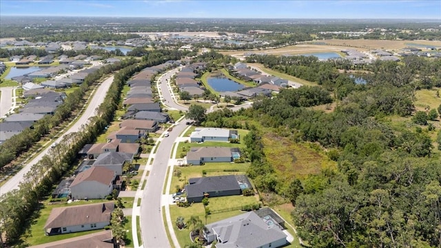 bird's eye view with a residential view and a water view