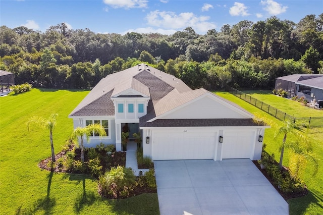 4515 Roycroft Ter, Parrish, FL 34219 - view of front of home featuring a garage, driveway, roof with shingles, and a wooded view