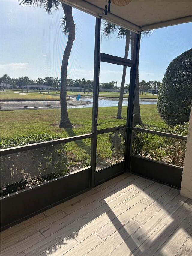 7050 Fairway Bend Ln Unit 167, Sarasota, FL 34243 - unfurnished sunroom featuring a water view
