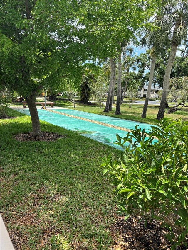 7050 Fairway Bend Ln Unit 167, Sarasota, FL 34243 - view of home's community featuring a yard and shuffleboard