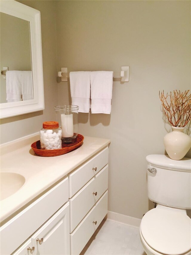 7050 Fairway Bend Ln Unit 167, Sarasota, FL 34243 - half bathroom featuring vanity, toilet, and baseboards