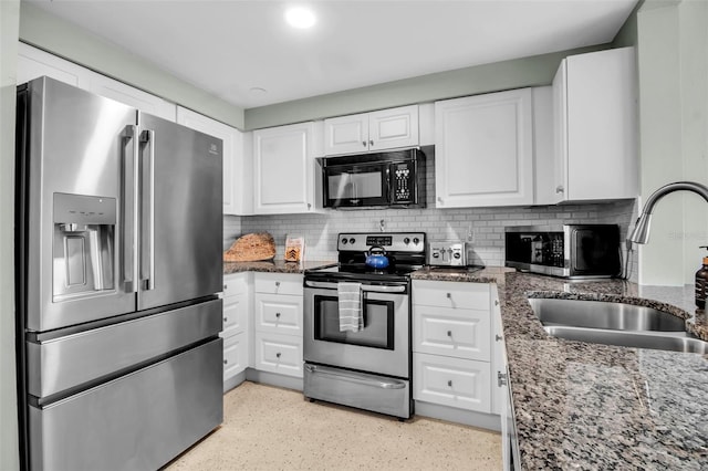 kitchen with decorative backsplash, stainless steel appliances, white cabinetry, and a sink