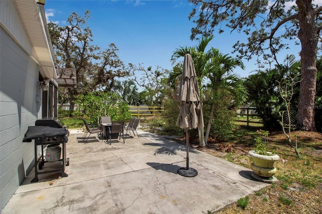 view of patio / terrace with outdoor dining area, fence, and grilling area