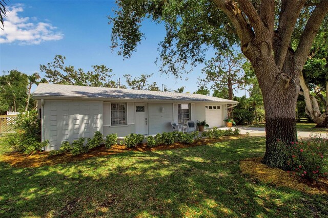 709 84th St NW, Bradenton, FL 34209 - ranch-style house featuring a garage, a front yard, concrete driveway, and concrete block siding