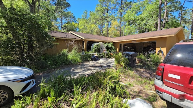 ranch-style house with an attached garage and stucco siding