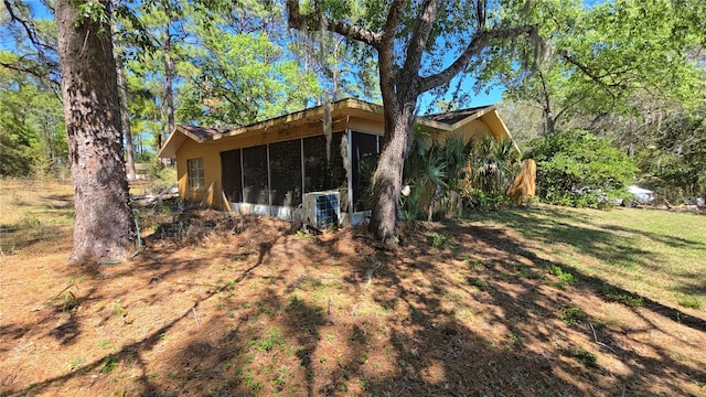 view of property exterior with a sunroom