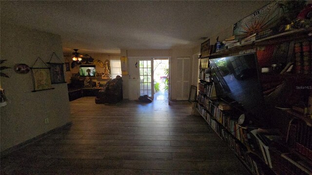 living room with wood-type flooring and a ceiling fan