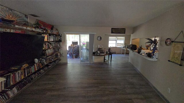hall with visible vents and wood finished floors