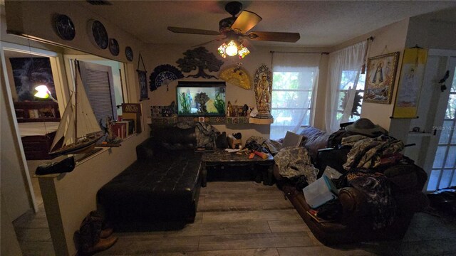 interior space with ceiling fan and wood finished floors