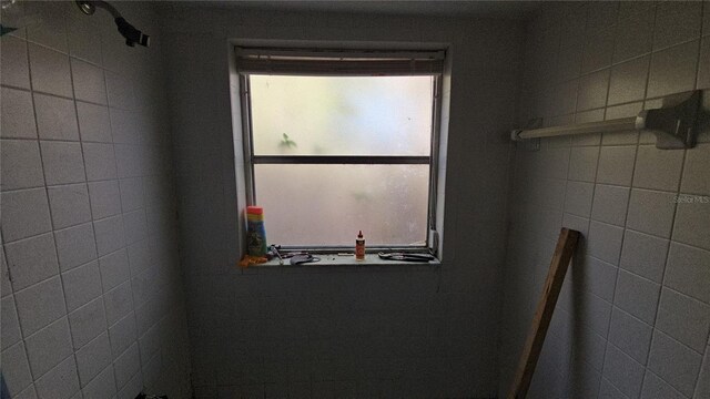 bathroom featuring plenty of natural light and a tile shower