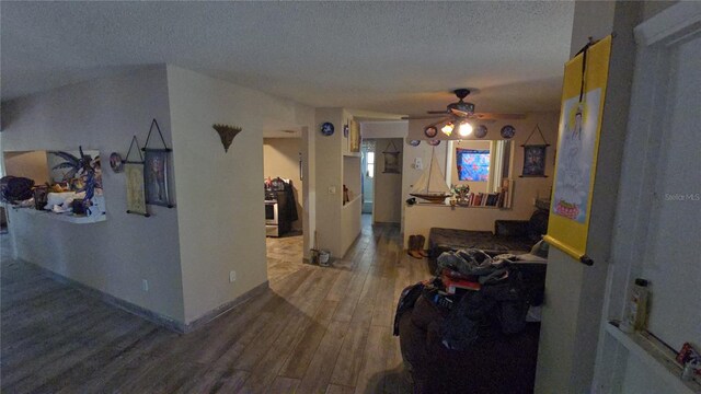 hallway featuring a textured ceiling and wood finished floors