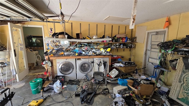 garage with washing machine and clothes dryer and a workshop area