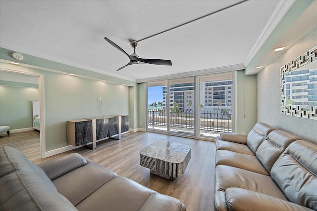 1212 Benjamin Franklin Dr Unit 306, Sarasota, FL 34236 - living area featuring ornamental molding, wood finished floors, a ceiling fan, and baseboards