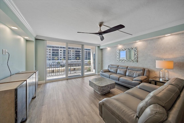 1212 Benjamin Franklin Dr Unit 306, Sarasota, FL 34236 - living room with wood finished floors, a ceiling fan, ornamental molding, and baseboards