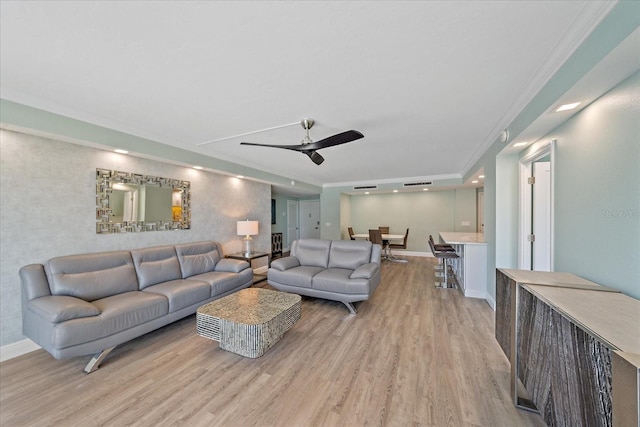 1212 Benjamin Franklin Dr Unit 306, Sarasota, FL 34236 - living area featuring a ceiling fan, light wood finished floors, baseboards, and crown molding