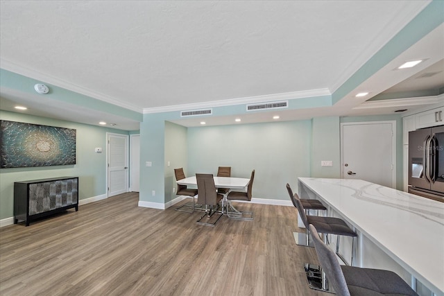 1212 Benjamin Franklin Dr Unit 306, Sarasota, FL 34236 - dining space featuring crown molding, light wood finished floors, baseboards, and recessed lighting