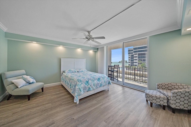 1212 Benjamin Franklin Dr Unit 306, Sarasota, FL 34236 - bedroom featuring floor to ceiling windows, wood finished floors, access to outside, crown molding, and baseboards