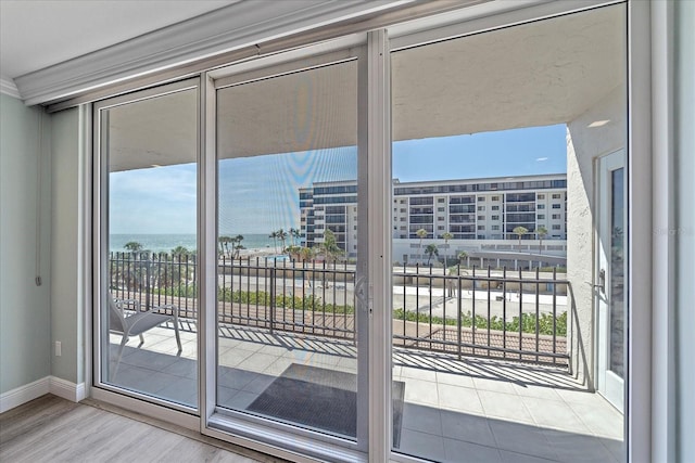 1212 Benjamin Franklin Dr Unit 306, Sarasota, FL 34236 - doorway with baseboards, wood finished floors, and a water view