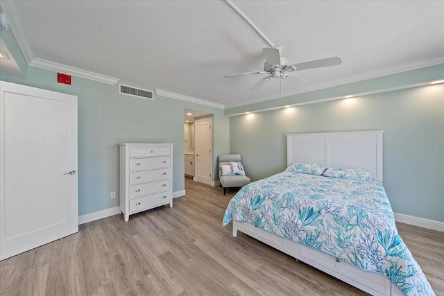 1212 Benjamin Franklin Dr Unit 306, Sarasota, FL 34236 - bedroom with crown molding, light wood-style floors, baseboards, a ceiling fan, and ensuite bathroom
