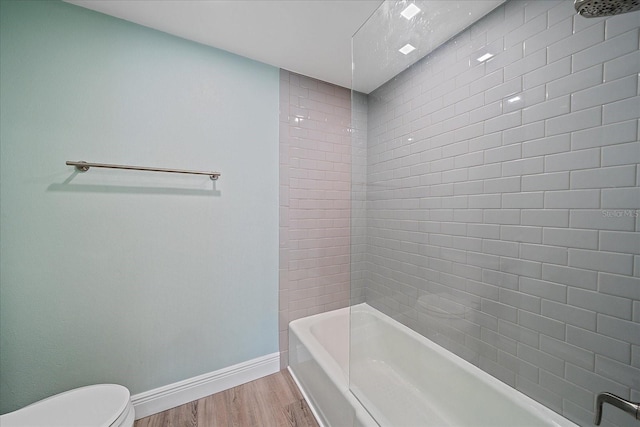 1212 Benjamin Franklin Dr Unit 306, Sarasota, FL 34236 - bathroom featuring wood finished floors, toilet, baseboards, and bathtub / shower combination