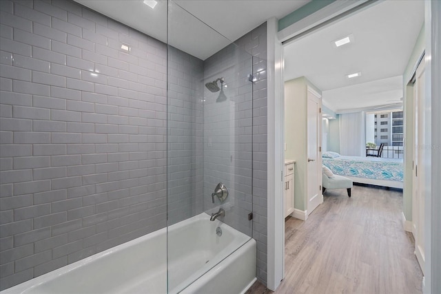 1212 Benjamin Franklin Dr Unit 306, Sarasota, FL 34236 - bathroom featuring wood finished floors, ensuite bath, shower / tub combination, and baseboards