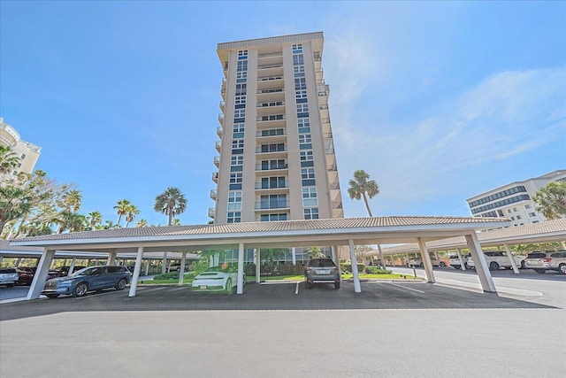 1212 Benjamin Franklin Dr Unit 306, Sarasota, FL 34236 - view of building exterior featuring covered parking