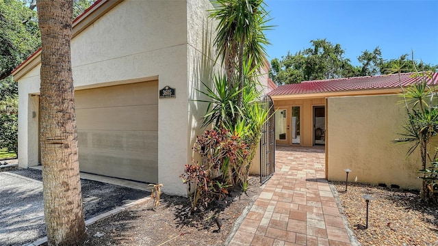3605 Quail Hollow Ln, Bradenton, FL 34210 - view of home's exterior with stucco siding, a tile roof, and a garage