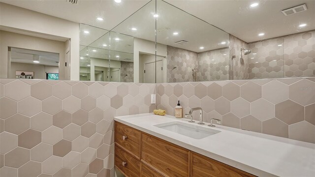 3605 Quail Hollow Ln, Bradenton, FL 34210 - bathroom with tile walls, recessed lighting, walk in shower, visible vents, and vanity