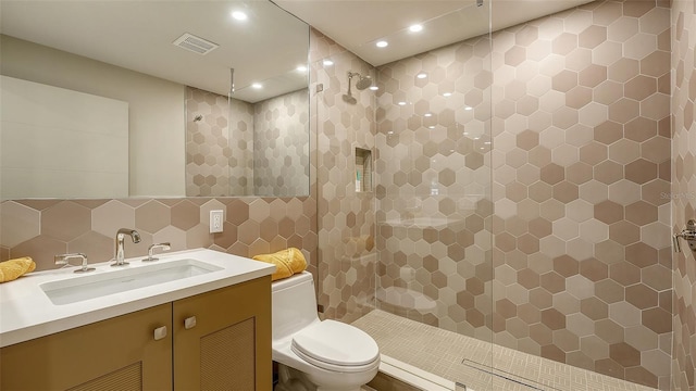3605 Quail Hollow Ln, Bradenton, FL 34210 - bathroom featuring toilet, tile walls, visible vents, walk in shower, and vanity