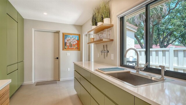 3605 Quail Hollow Ln, Bradenton, FL 34210 - kitchen featuring a sink, a healthy amount of sunlight, light countertops, and green cabinetry