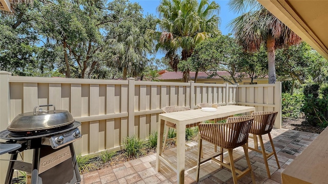 3605 Quail Hollow Ln, Bradenton, FL 34210 - exterior space with grilling area, fence, and outdoor dining space