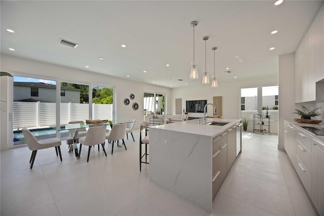 2590 Floyd St, Sarasota, FL 34239 - kitchen with modern cabinets, a sink, black electric stovetop, white cabinets, and recessed lighting