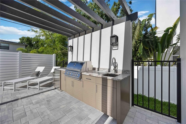 2590 Floyd St, Sarasota, FL 34239 - view of patio / terrace with a sink, exterior kitchen, grilling area, fence, and a pergola