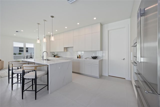 2590 Floyd St, Sarasota, FL 34239 - kitchen with modern cabinets, a kitchen breakfast bar, white cabinets, a sink, and black electric stovetop