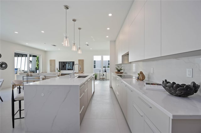 2590 Floyd St, Sarasota, FL 34239 - kitchen with a sink, modern cabinets, healthy amount of natural light, recessed lighting, and a spacious island