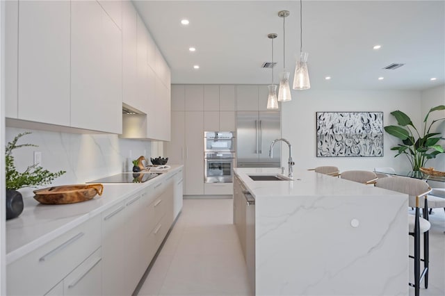 2590 Floyd St, Sarasota, FL 34239 - kitchen featuring a sink, appliances with stainless steel finishes, modern cabinets, a breakfast bar area, and recessed lighting