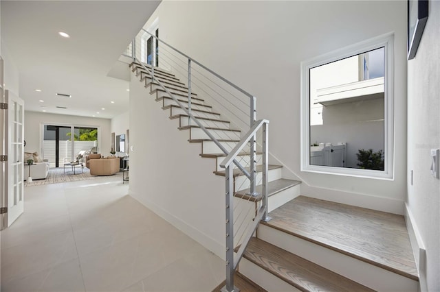 2590 Floyd St, Sarasota, FL 34239 - stairway with recessed lighting, french doors, baseboards, and tile patterned floors