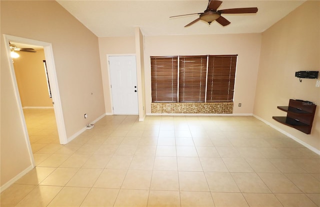2521 Tamarind Dr, Edgewater, FL 32141 - unfurnished living room featuring baseboards, light tile patterned floors, and ceiling fan