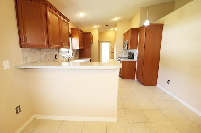 2521 Tamarind Dr, Edgewater, FL 32141 - kitchen featuring tasteful backsplash, stainless steel appliances, a peninsula, and light countertops