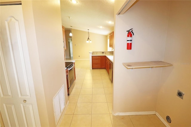 2521 Tamarind Dr, Edgewater, FL 32141 - kitchen featuring light tile patterned floors, light countertops, visible vents, baseboards, and hanging light fixtures