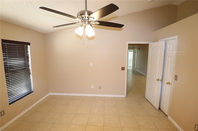 2521 Tamarind Dr, Edgewater, FL 32141 - unfurnished room featuring baseboards, light tile patterned floors, ceiling fan, and a textured ceiling