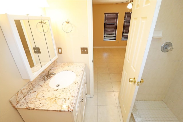 2521 Tamarind Dr, Edgewater, FL 32141 - full bathroom featuring tile patterned floors, ceiling fan, a tile shower, and vanity