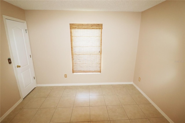 2521 Tamarind Dr, Edgewater, FL 32141 - spare room with light tile patterned floors and baseboards
